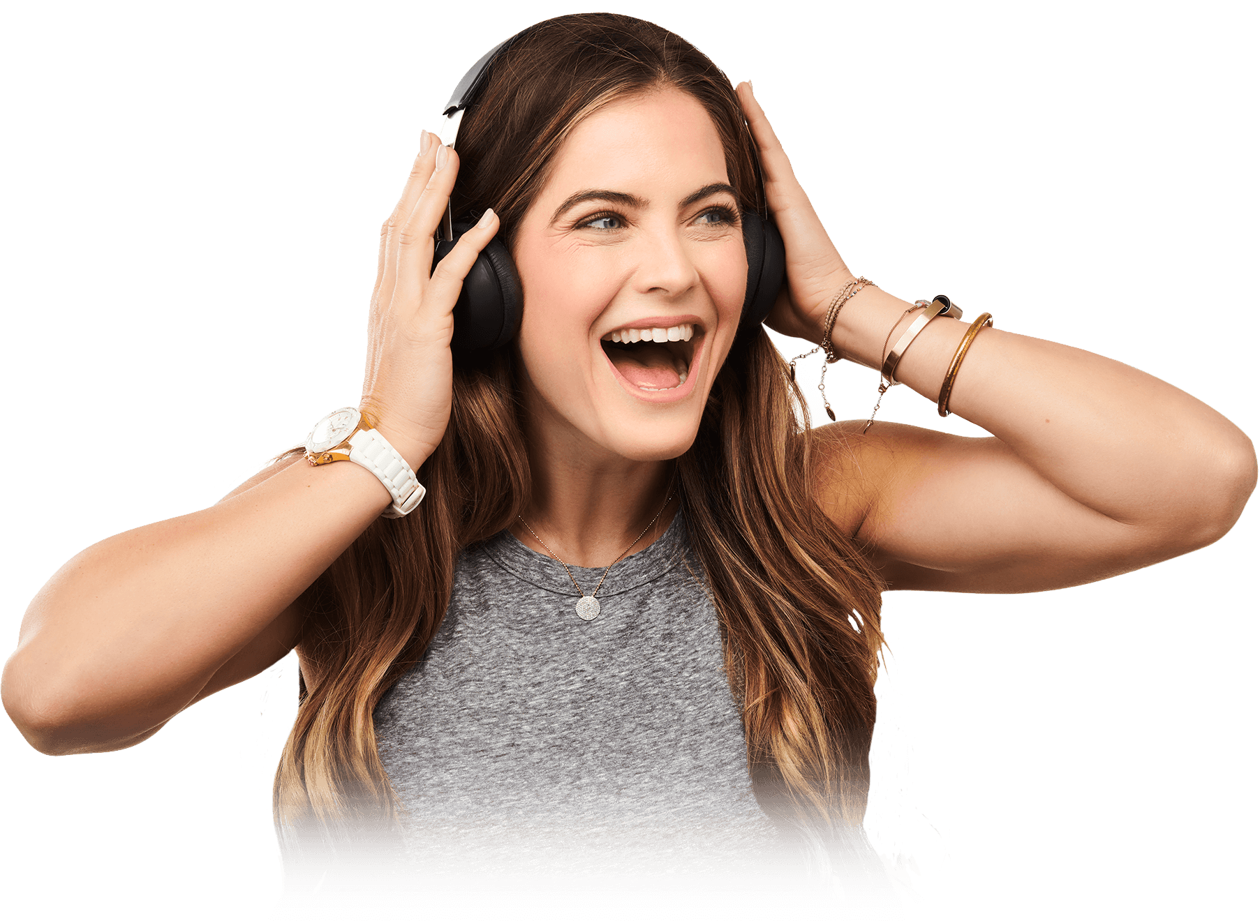 A young woman smiling as she listens to music through headphones